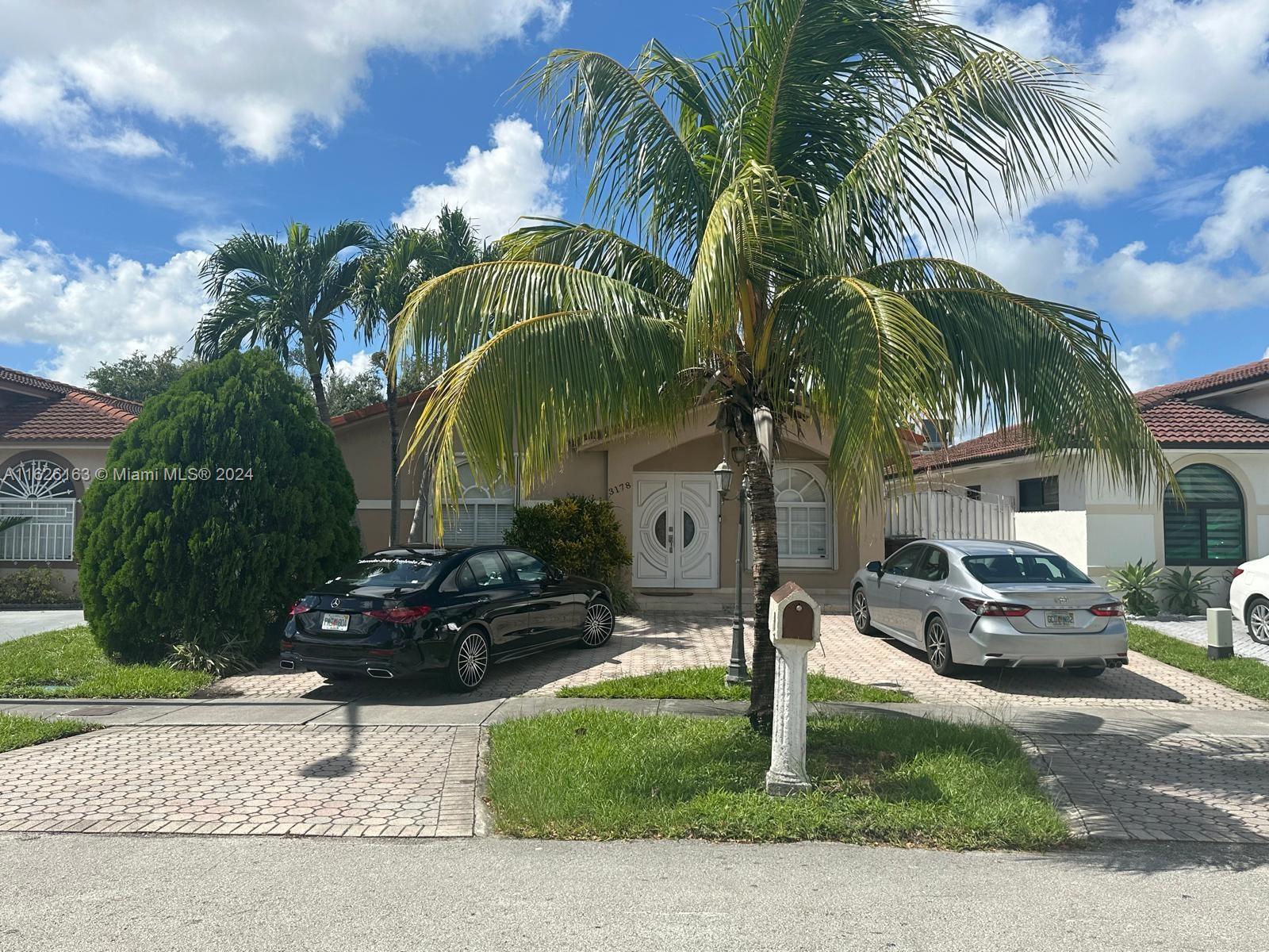 a front view of multiple houses with yard