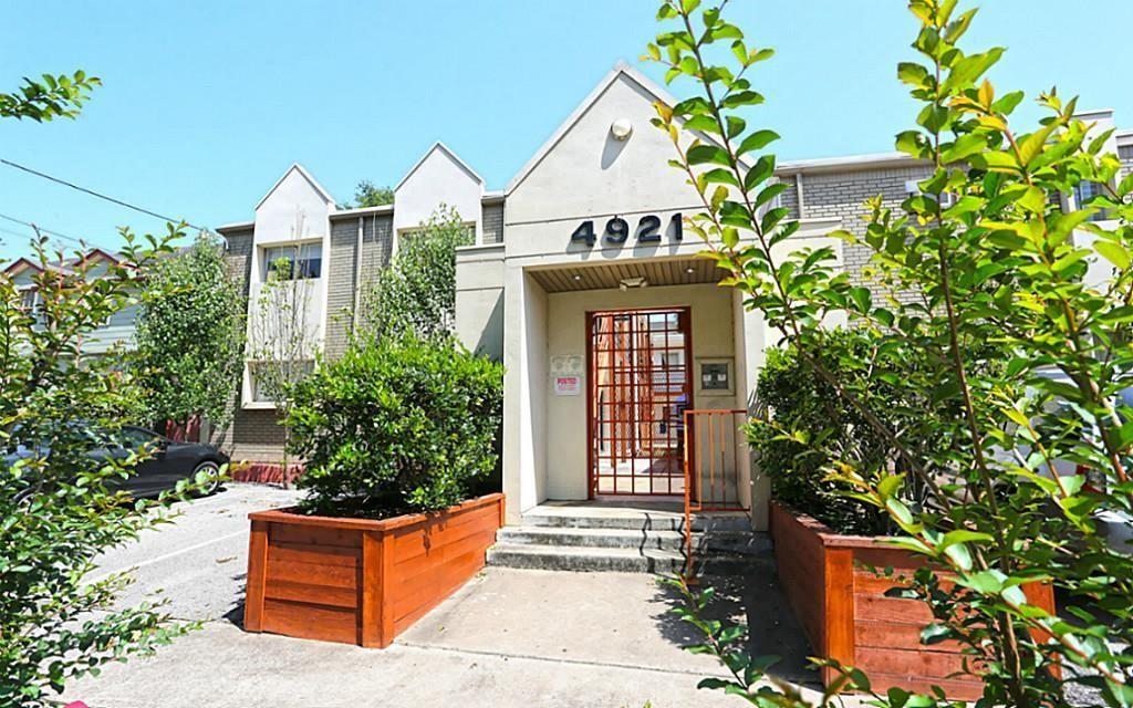 front view of house with a yard and potted plants