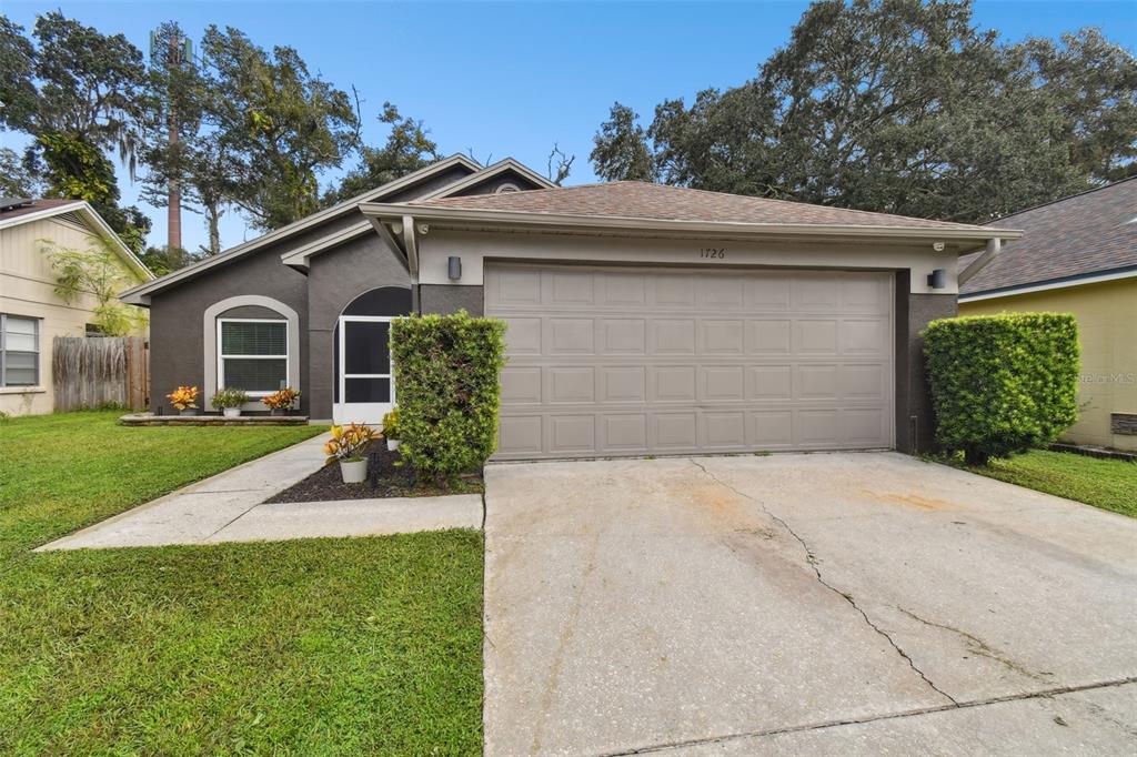 a front view of a house with a yard and garage