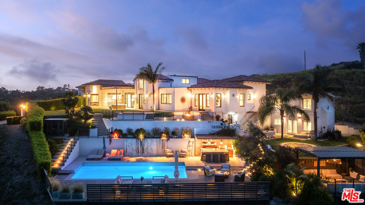 a view of a swimming pool with an outdoor seating