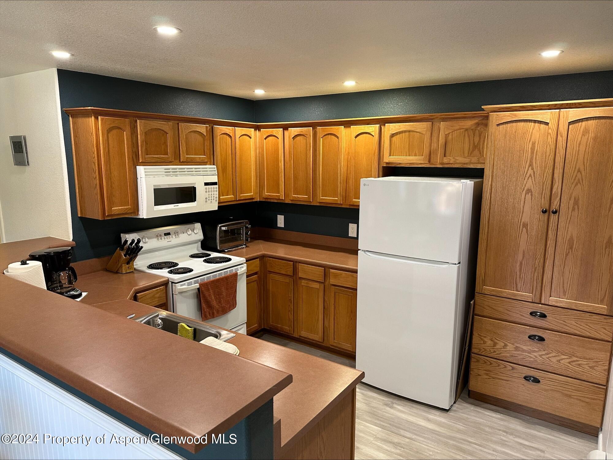 a kitchen with a refrigerator and a stove