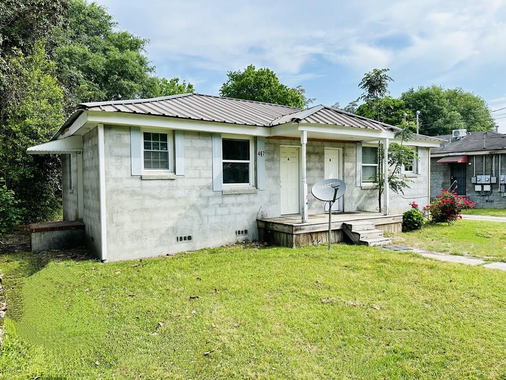 a front view of house with yard and outdoor seating