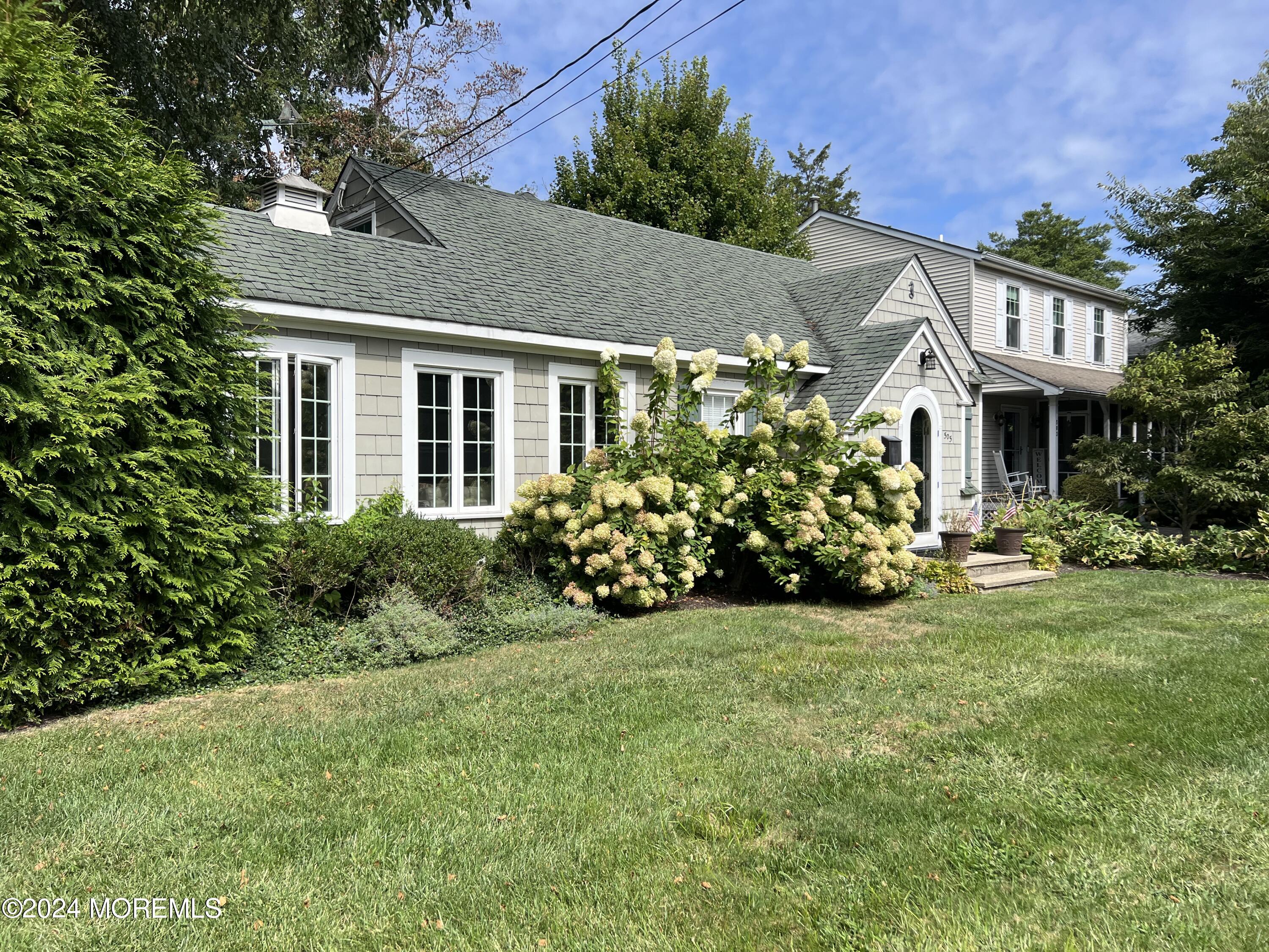 a front view of a house with a garden