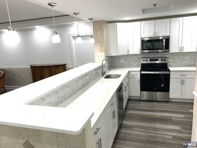 a large kitchen with a stove and a sink