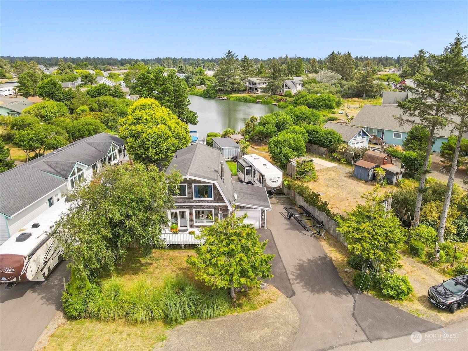 an aerial view of residential houses with outdoor space and river