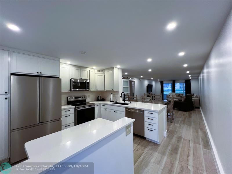 a kitchen with refrigerator and cabinets