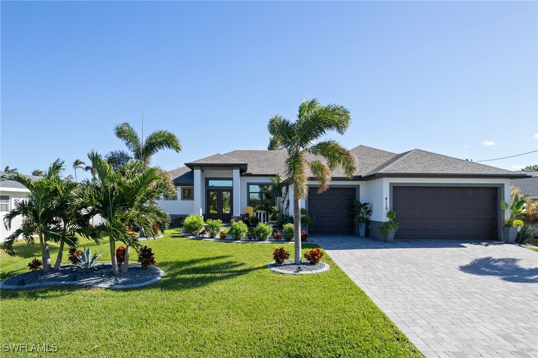 a front view of a house with a yard and garage