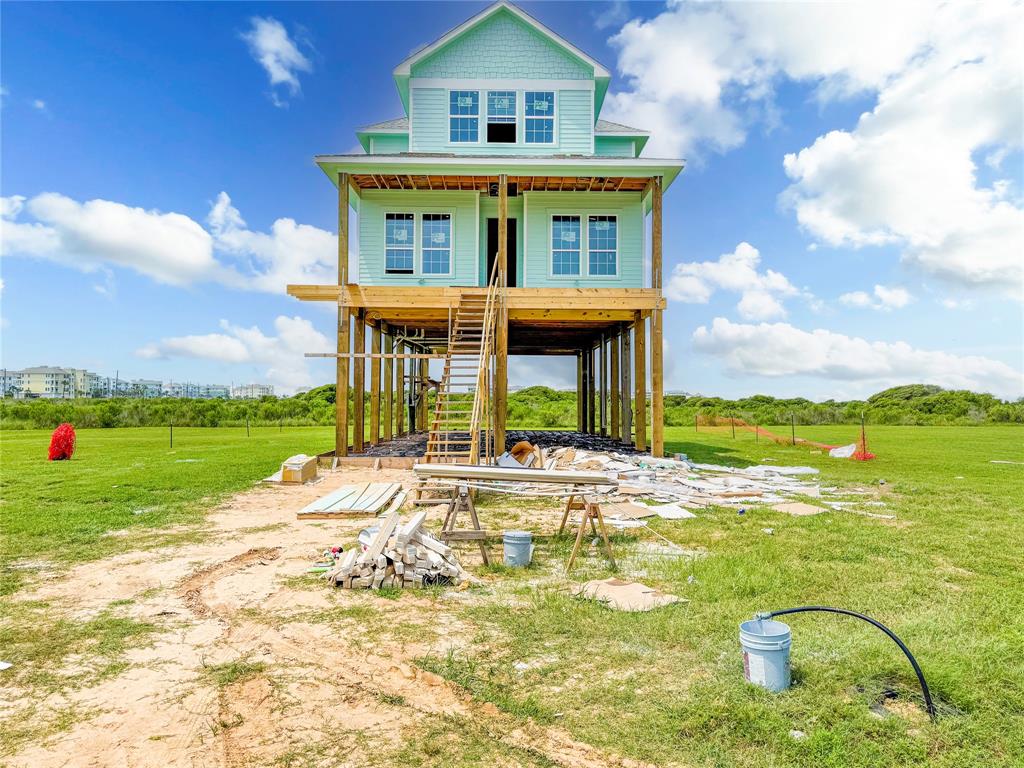 a view of a house with a swimming pool and a yard