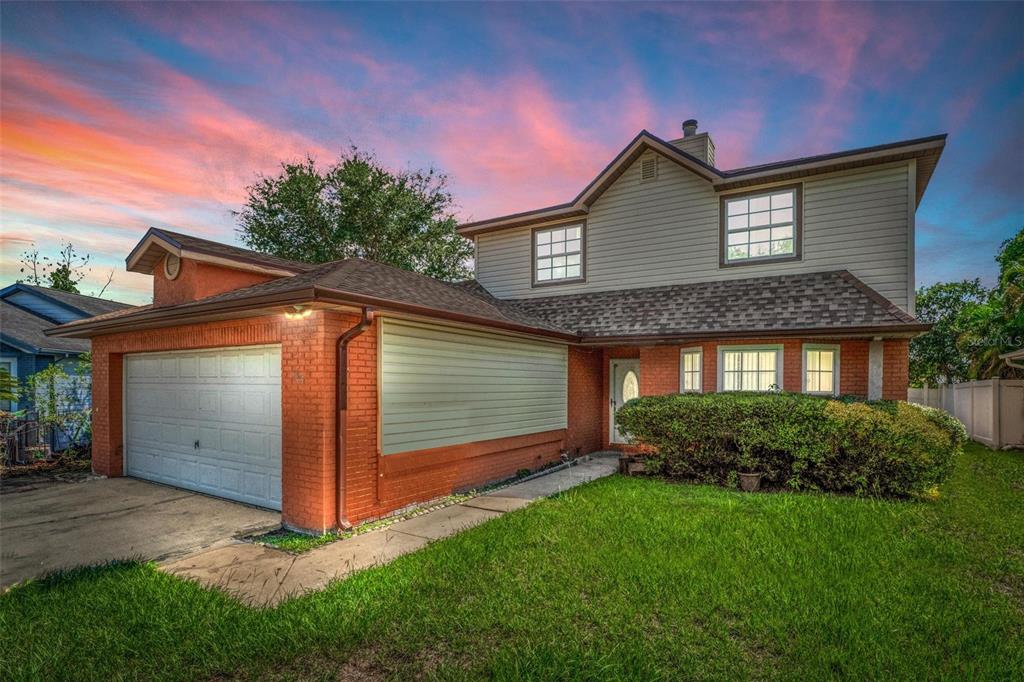 a front view of a house with a yard and garage