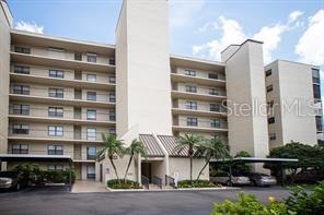 a front view of multi story residential apartment building with a yard