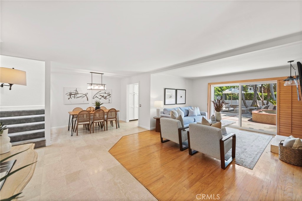 a living room with furniture and a table with wooden floor