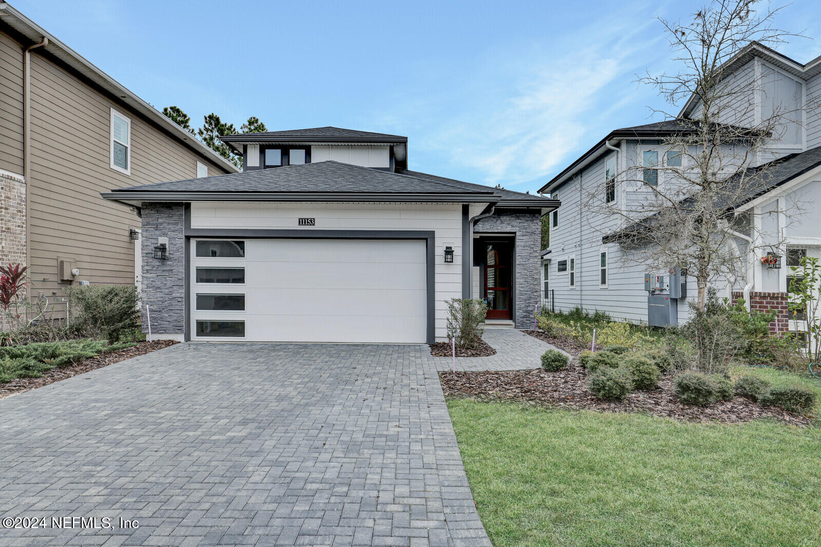 a front view of a house with a yard and garage