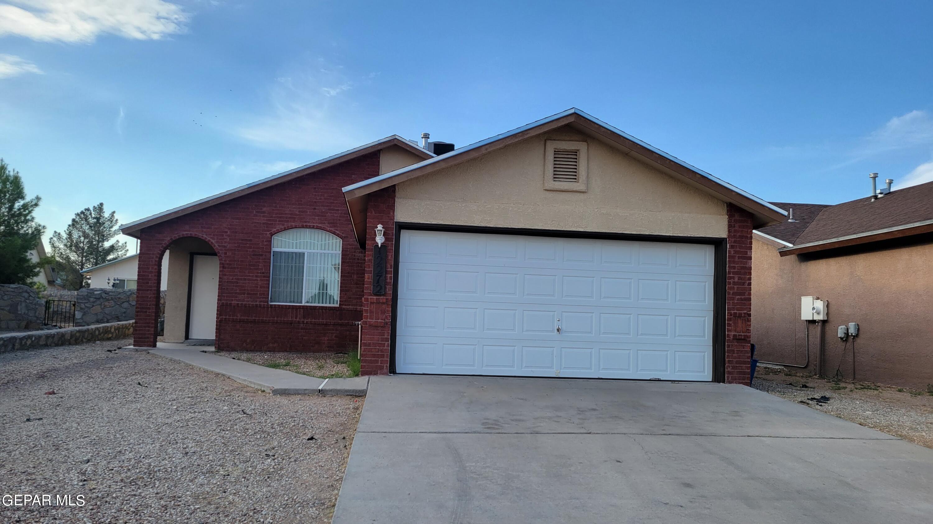 a front view of a house with a garage