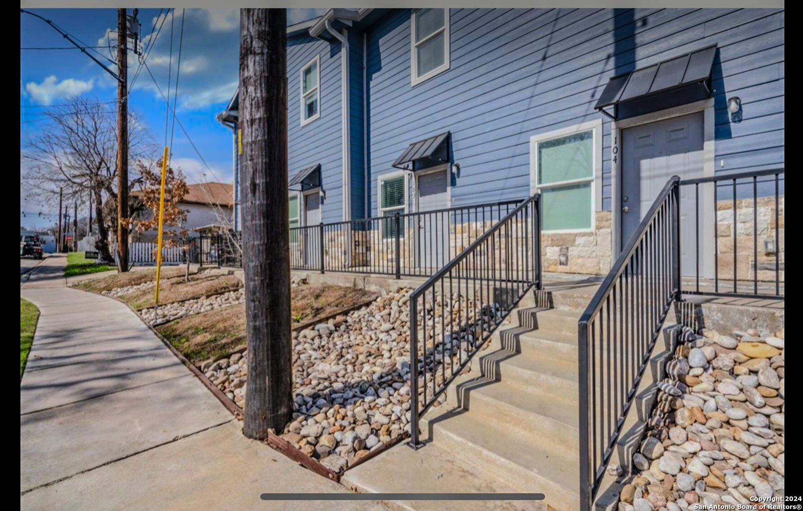 a view of a pathway of a house with wooden floor and fence