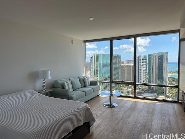 a bedroom with a bed and a large window