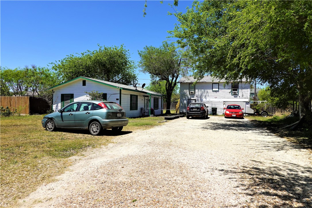 a view of a cars park in front of a house