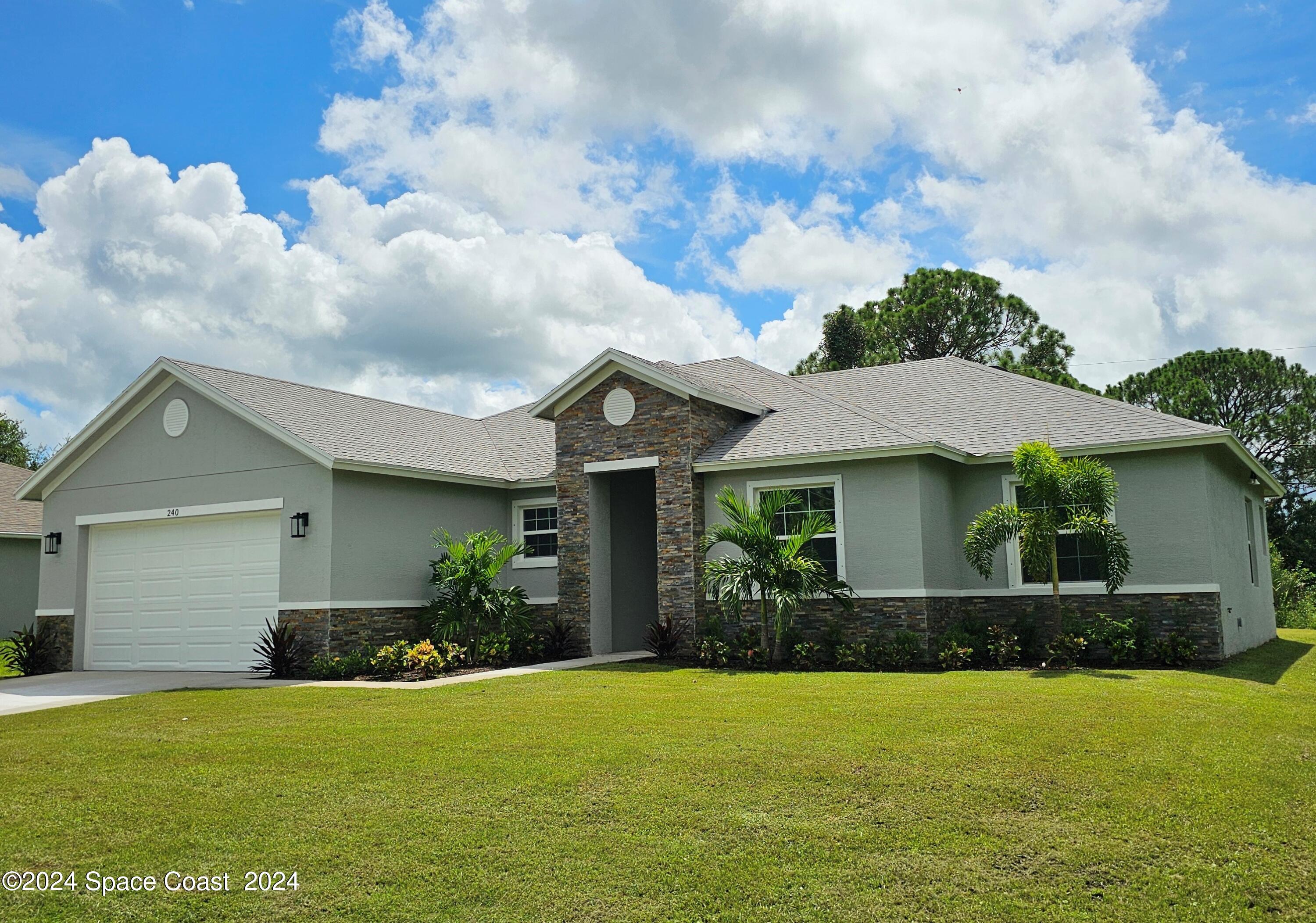 a front view of house with yard and green space