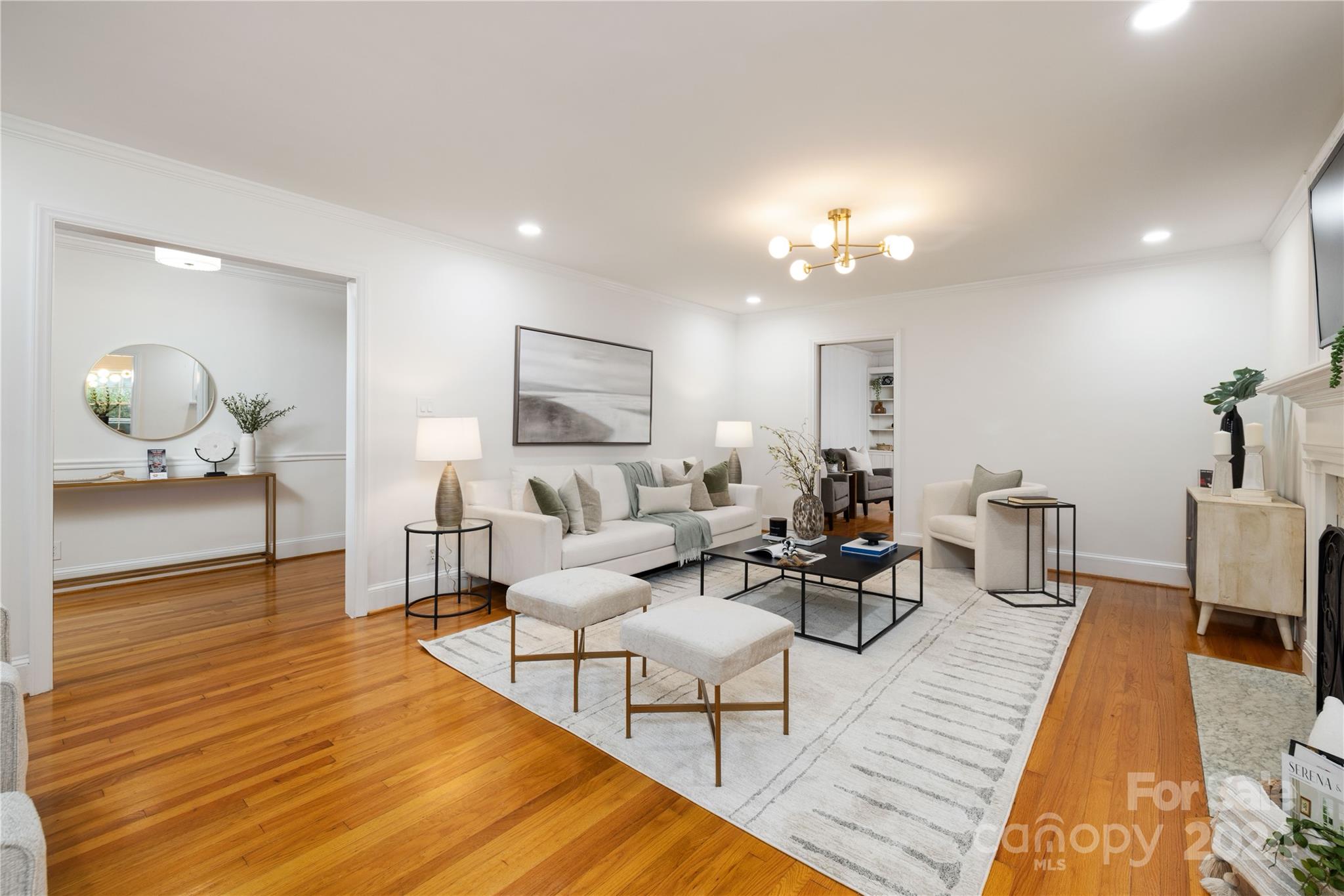 a living room with furniture and a chandelier