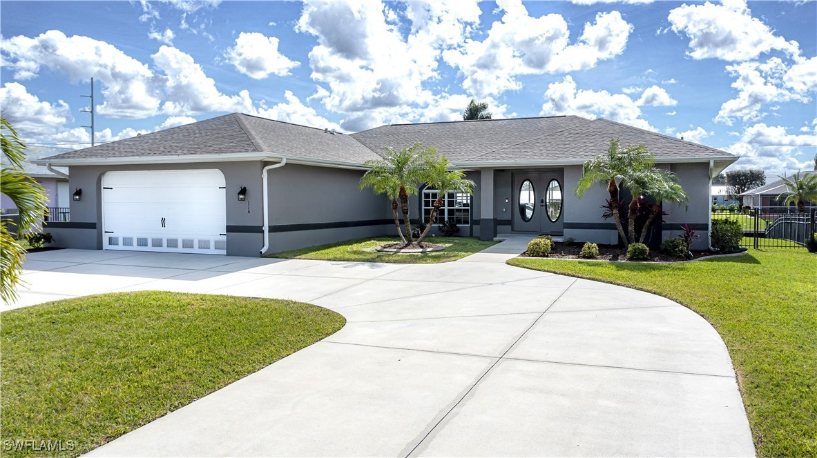 a view of a house with a swimming pool and a yard