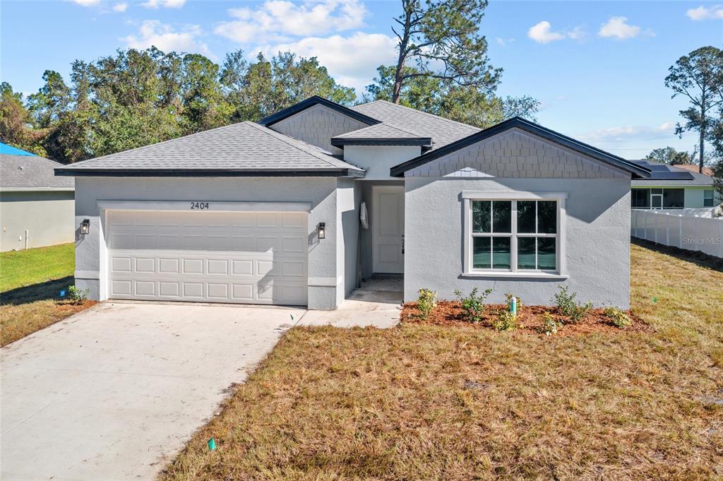 a front view of a house with a yard and garage