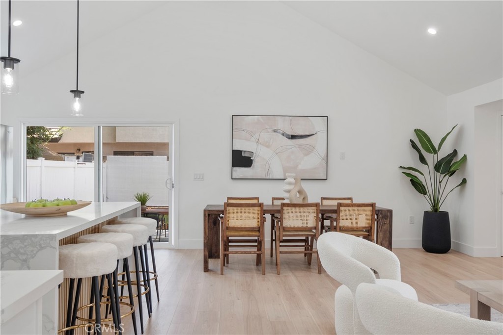 a dining room with furniture and wooden floor