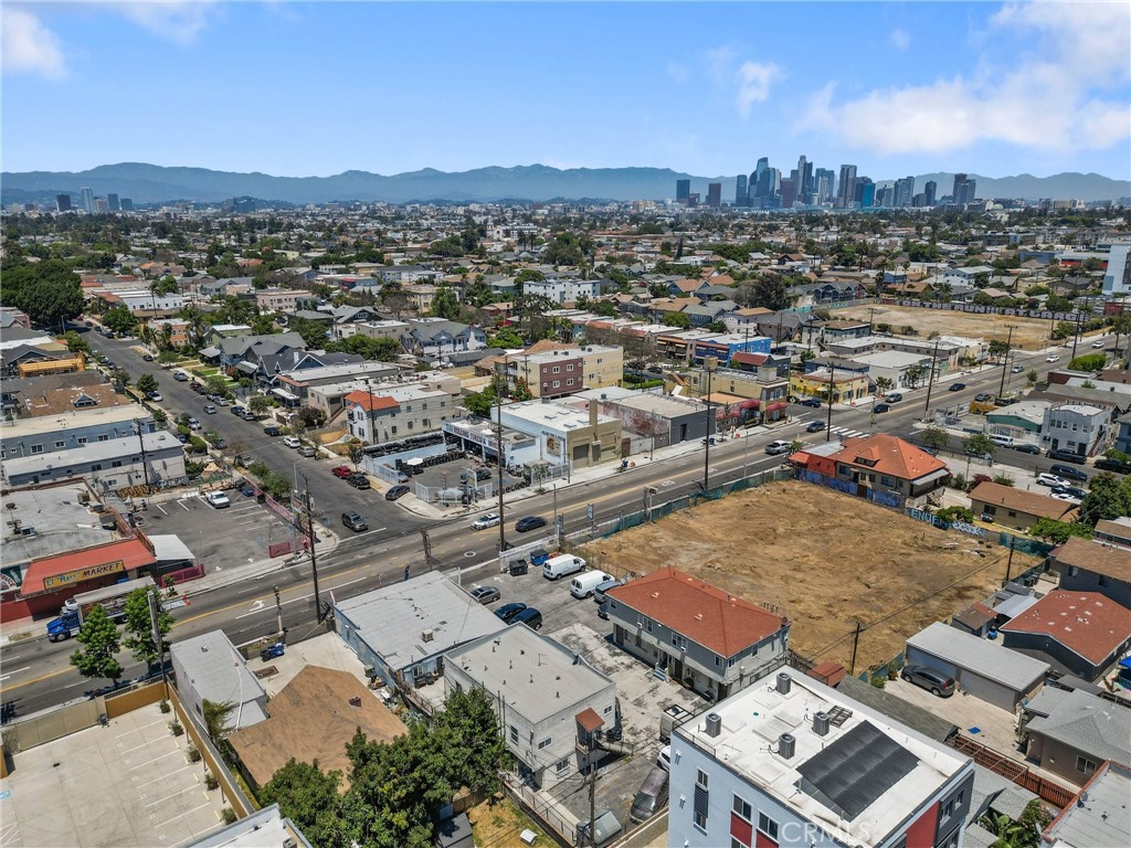 an aerial view of residential houses with city view