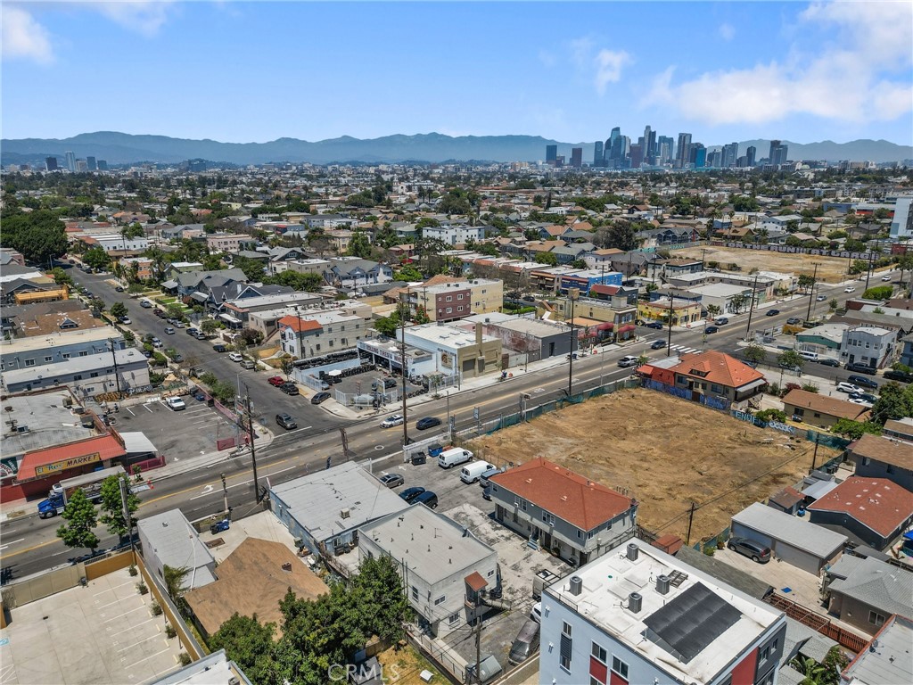 an aerial view of residential houses with city view