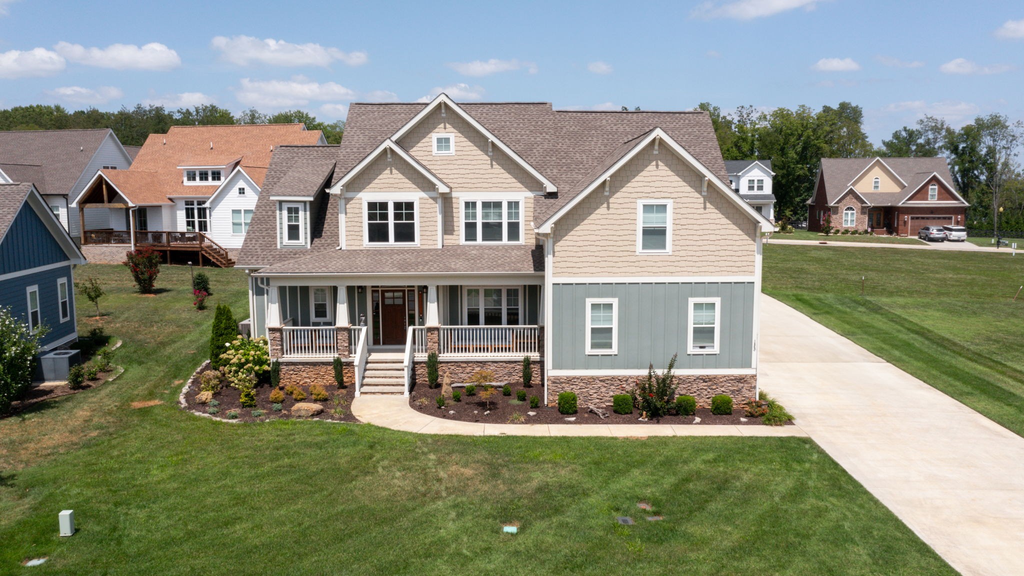 a aerial view of a house with a yard table and chairs