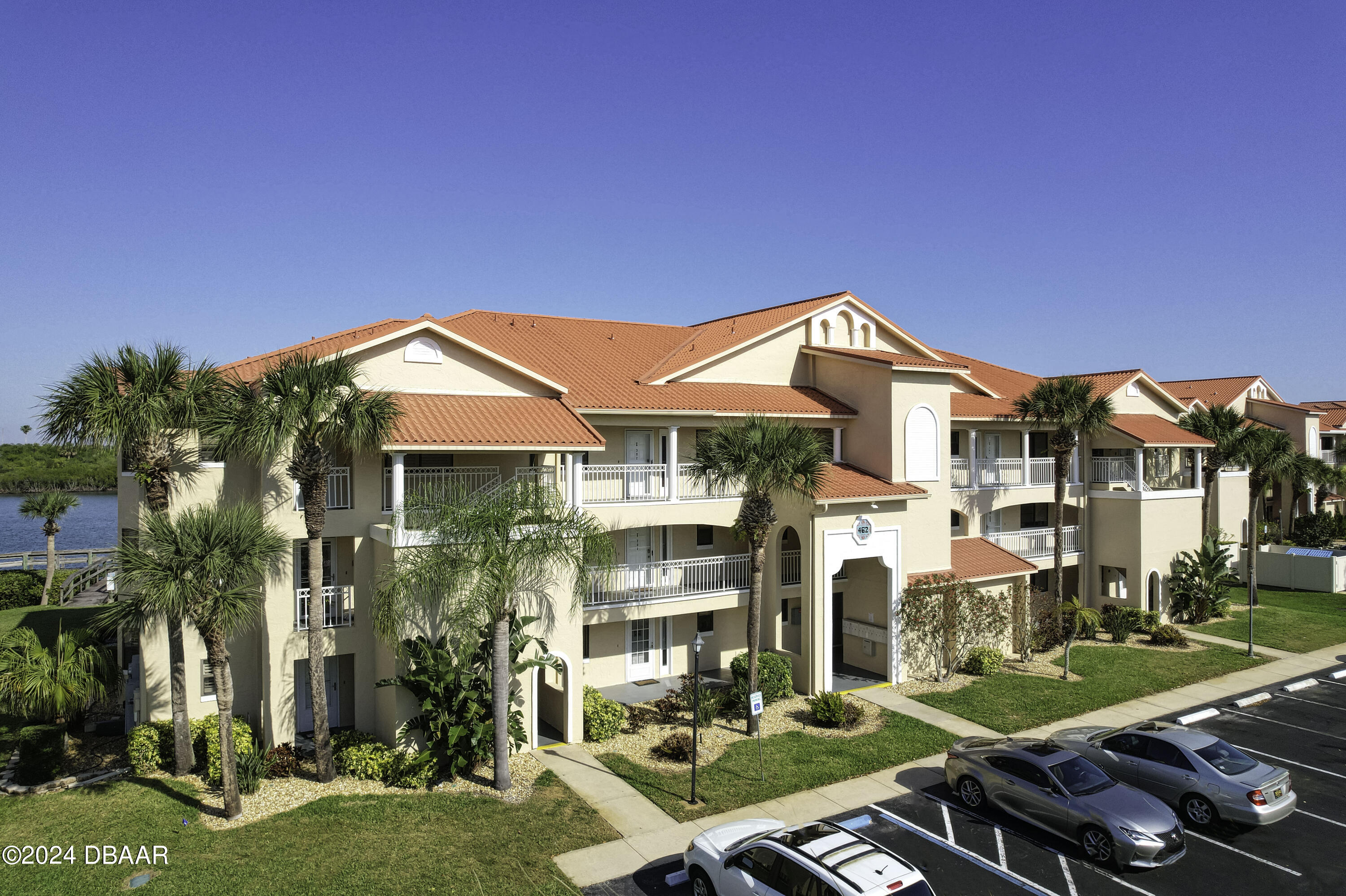 a front view of a residential apartment building with a yard