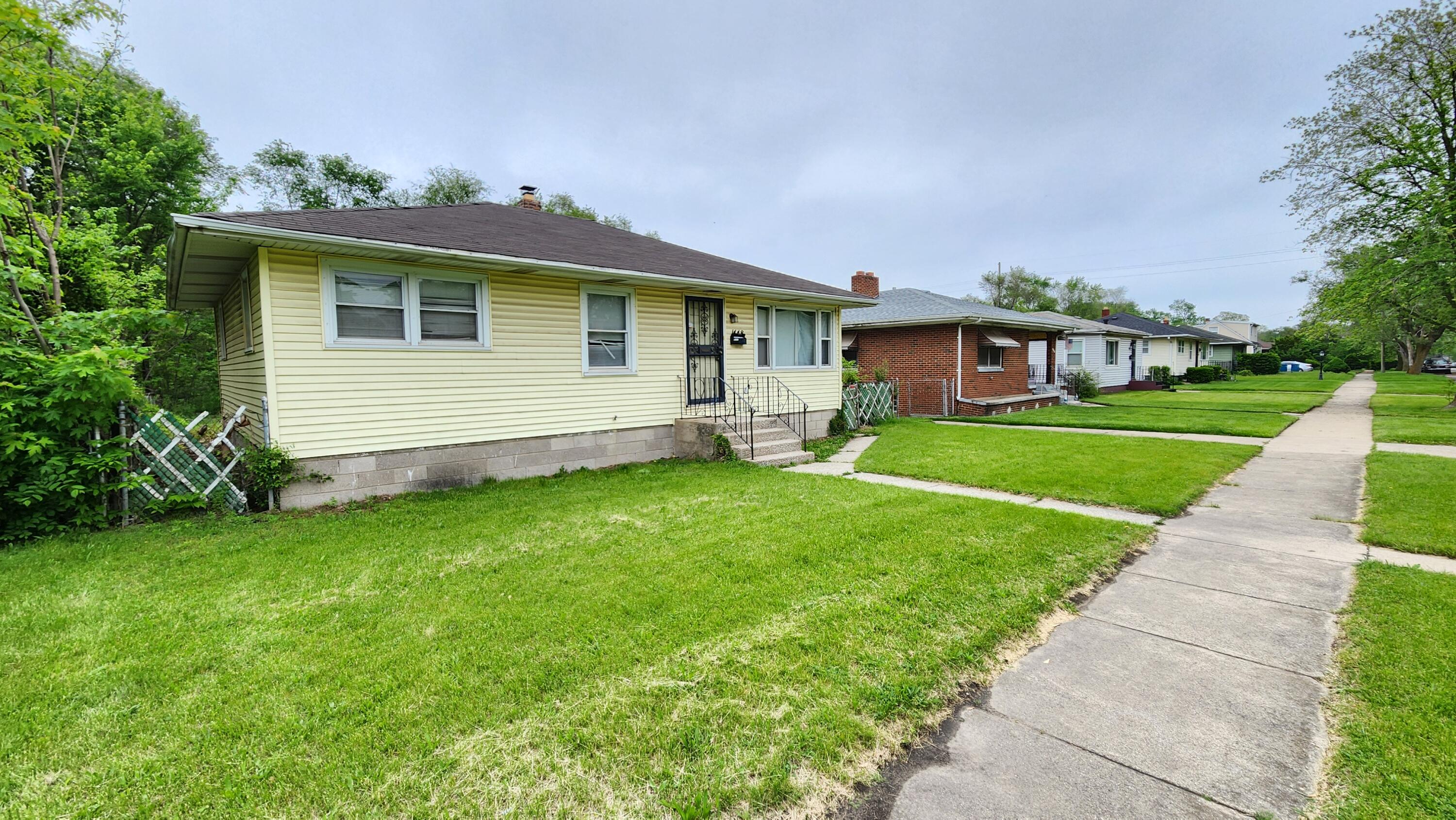 a front view of house with yard and green space