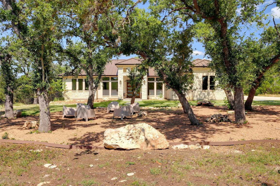 a front view of a house with a tree