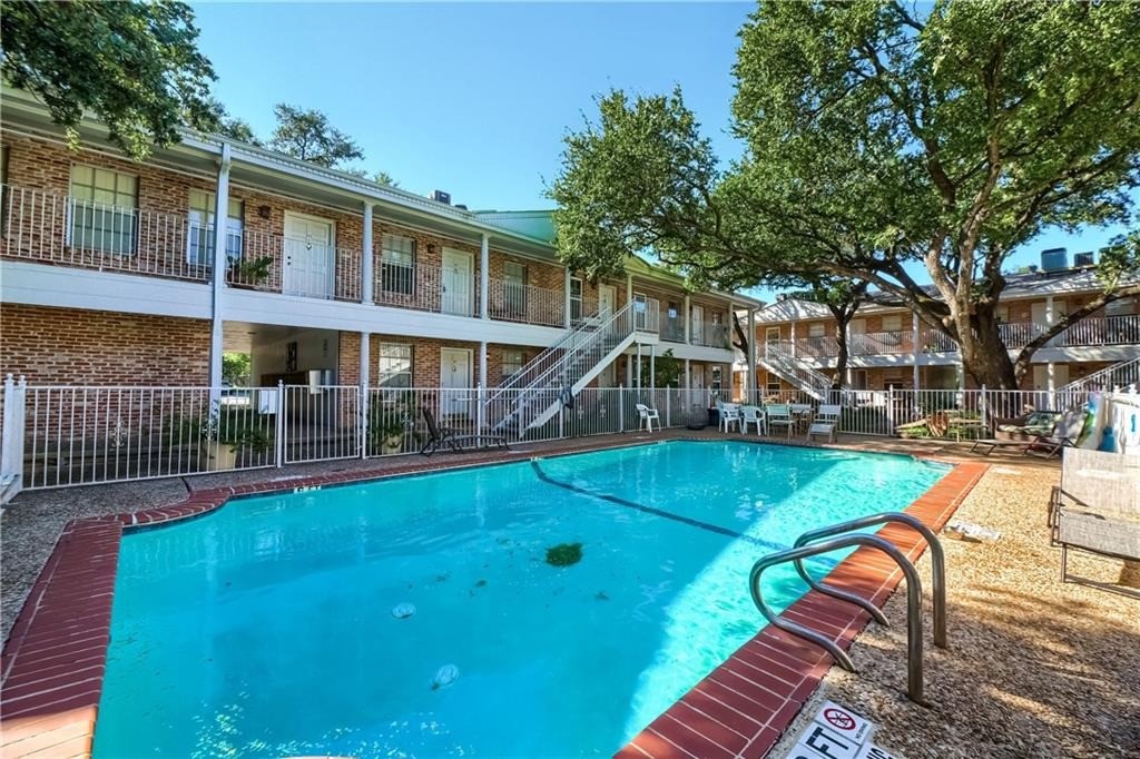 a view of a house with swimming pool and sitting area