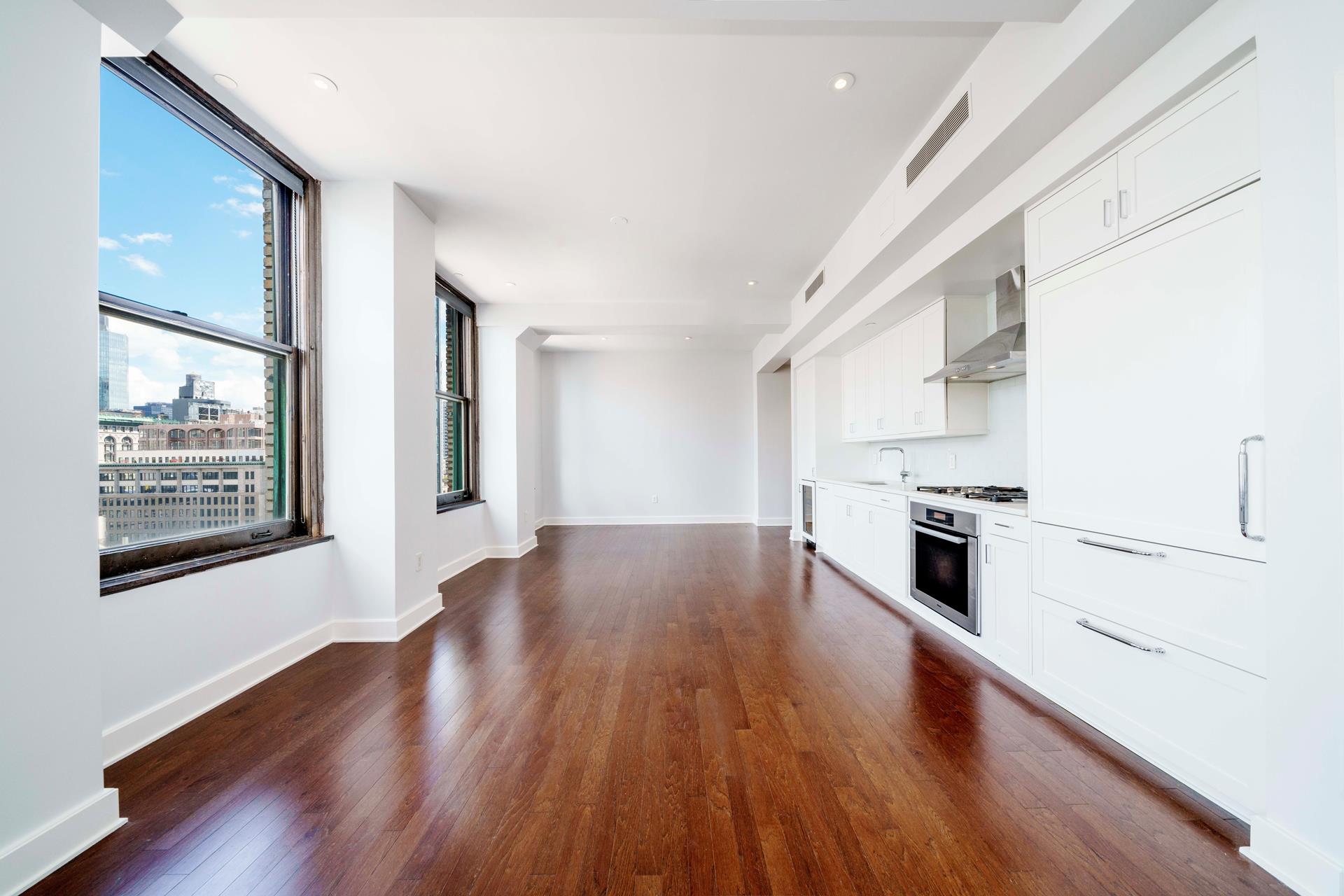 a kitchen with granite countertop wooden floors and white stainless steel appliances