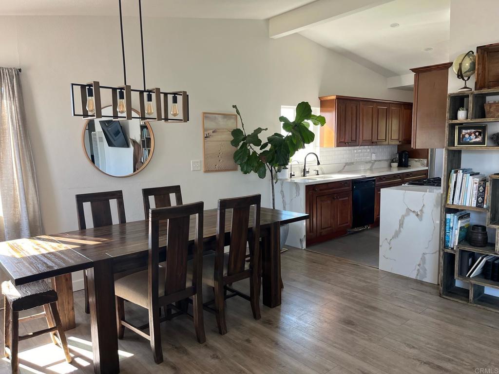 a dining room with furniture and wooden floor