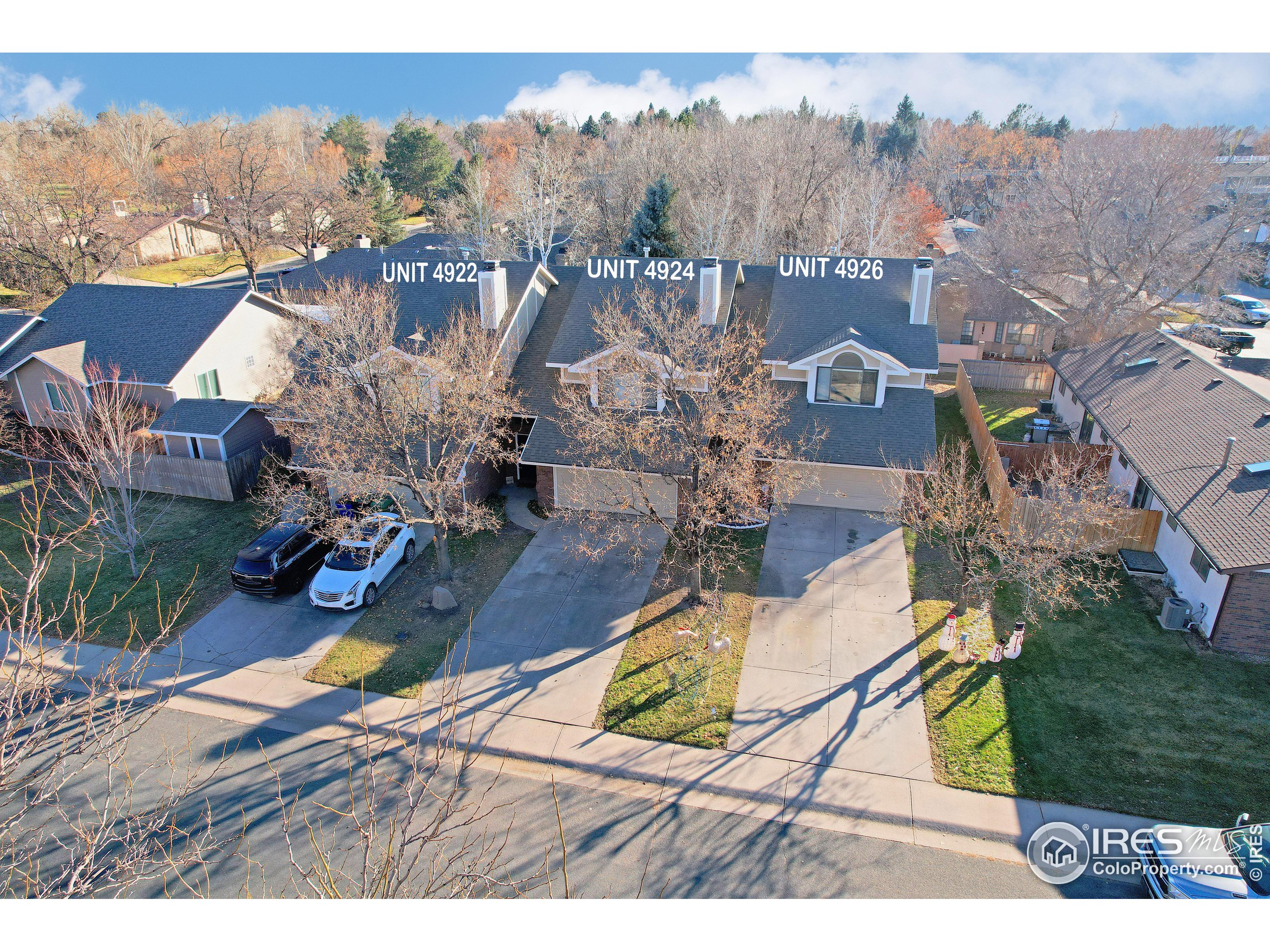 an aerial view of a house with a garden and lake view