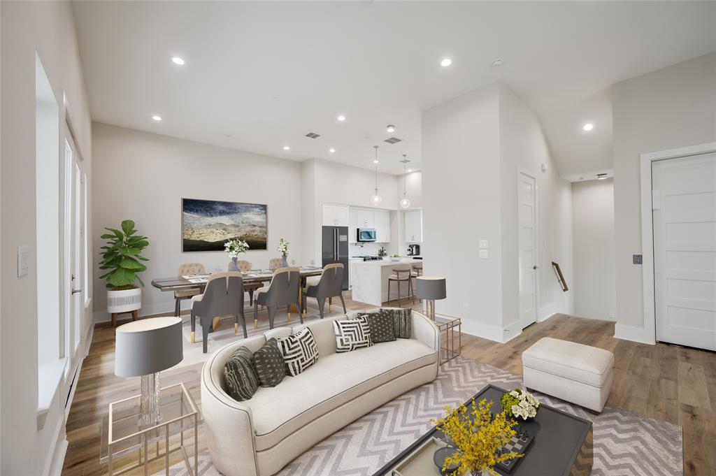 a living room with furniture a flat screen tv and a large window