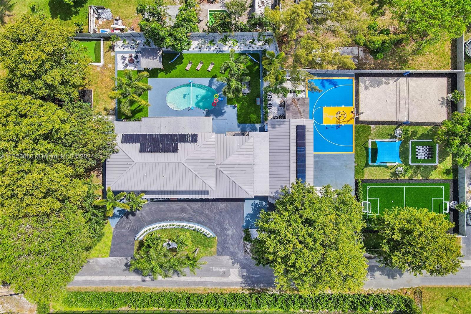 an aerial view of residential houses with outdoor space and street view