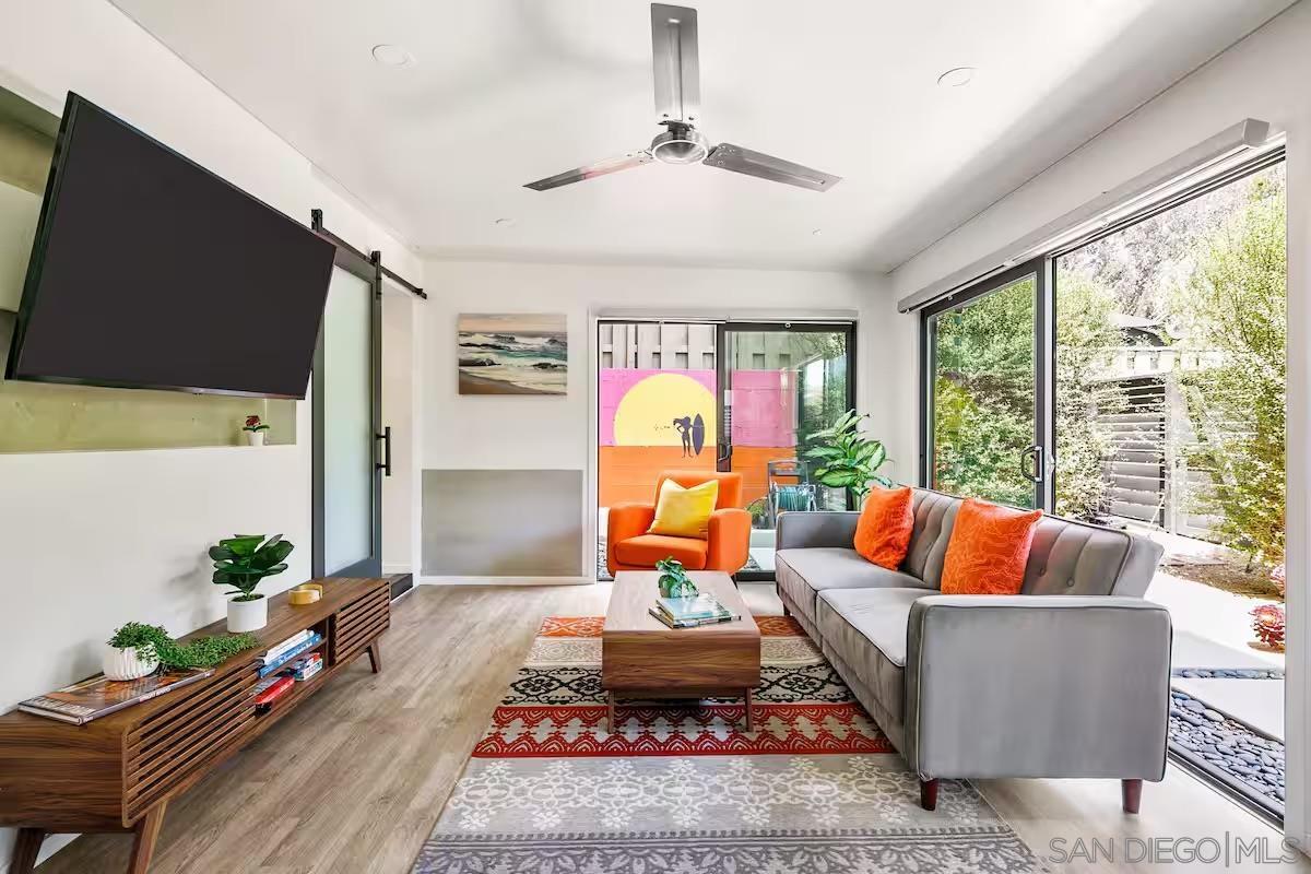 a living room with furniture fireplace and a large window