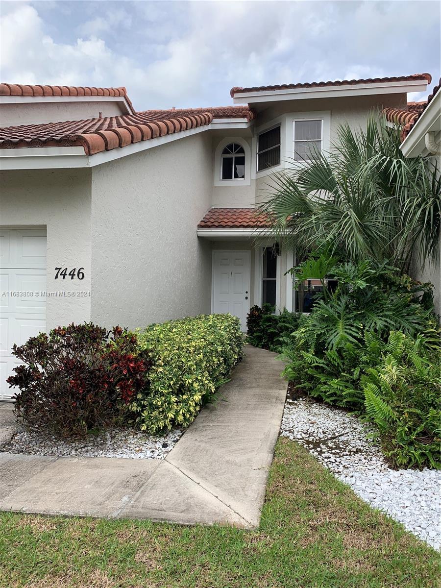 a front view of a house with garden