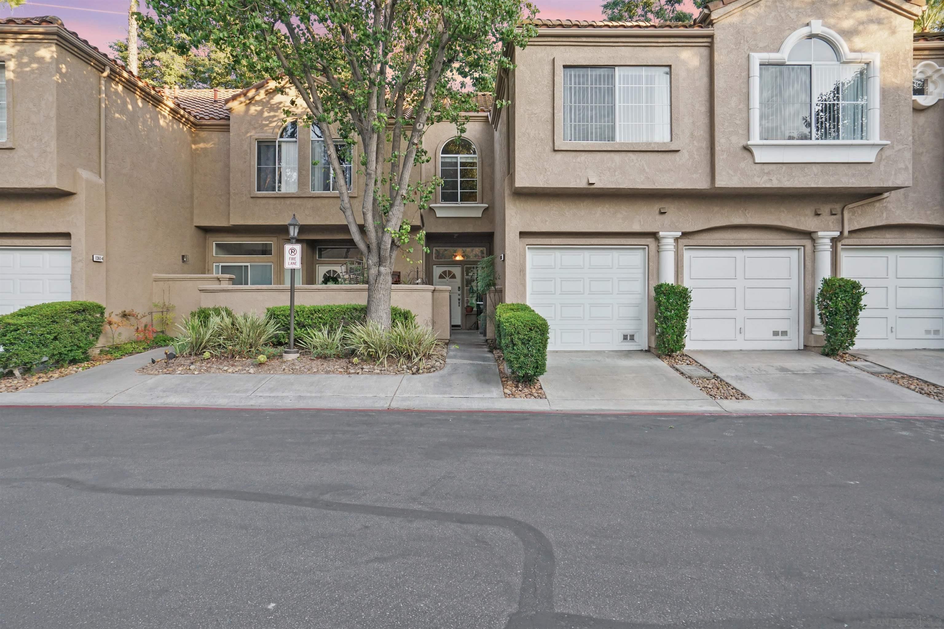 a front view of a house with a yard and a garage