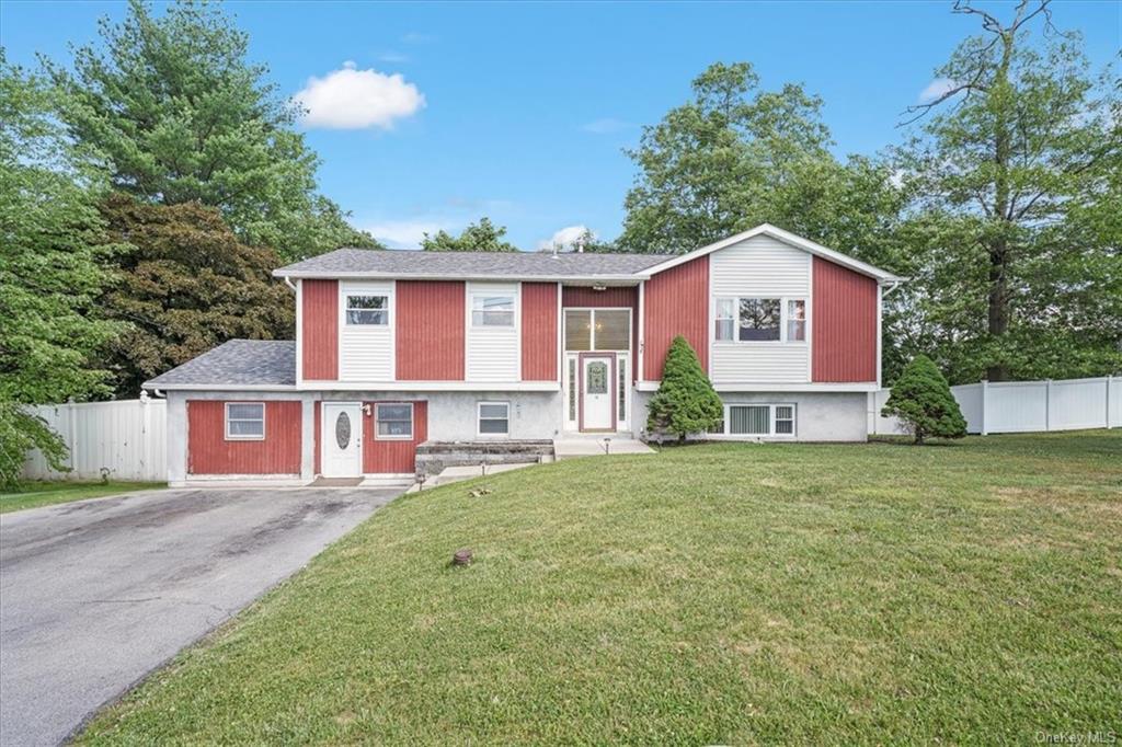 Split foyer home featuring a front yard