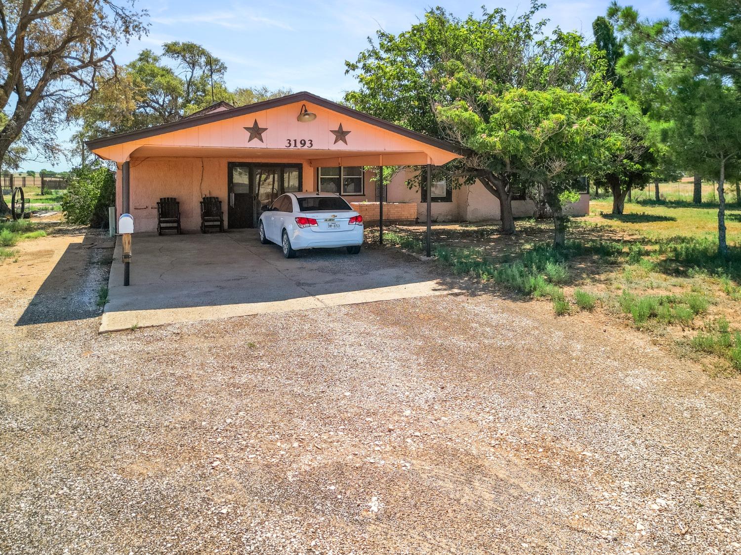 a outdoor view of a house with garden and trees