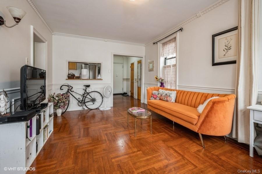 a living room with furniture a flat screen tv and a window