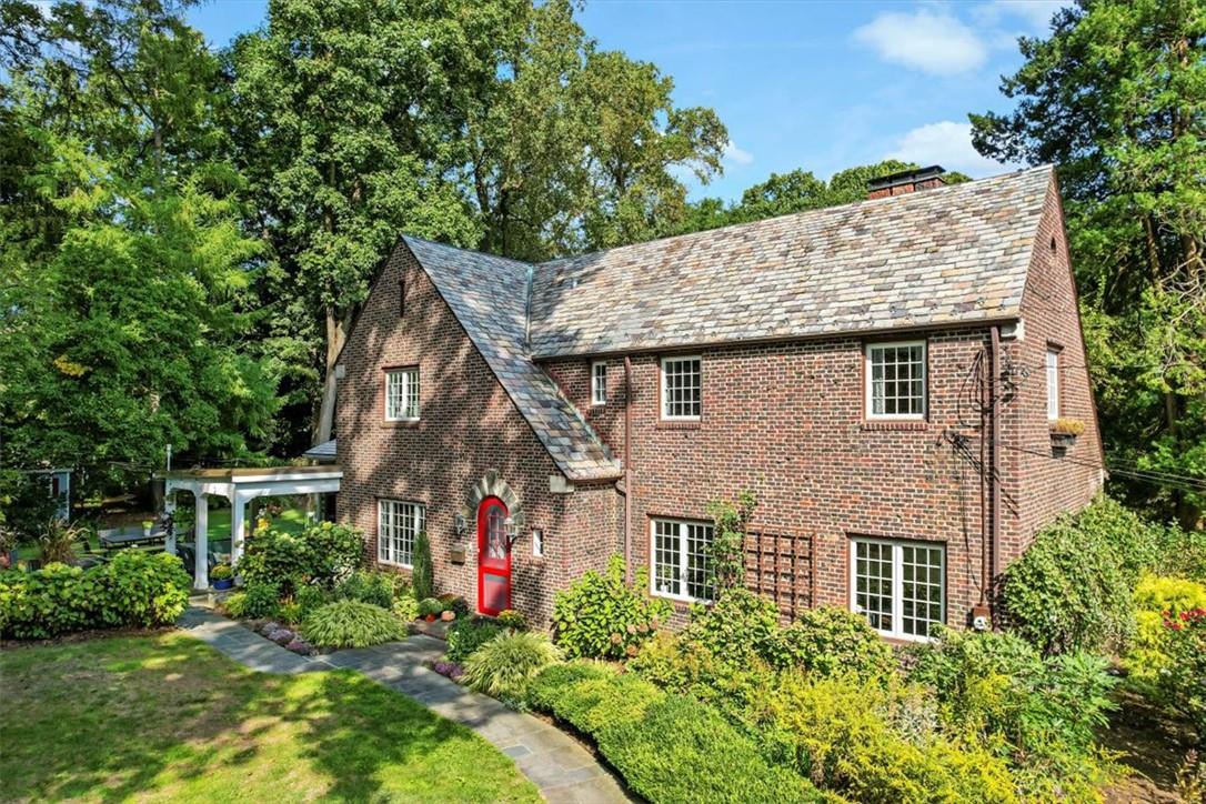 a aerial view of a house with a yard and potted plants