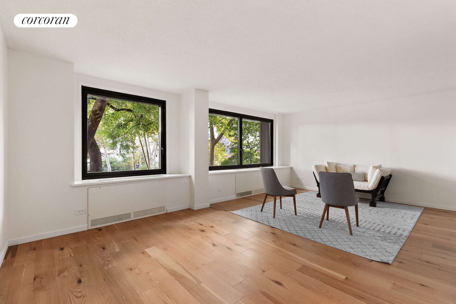 a view of a livingroom with furniture window and wooden floor