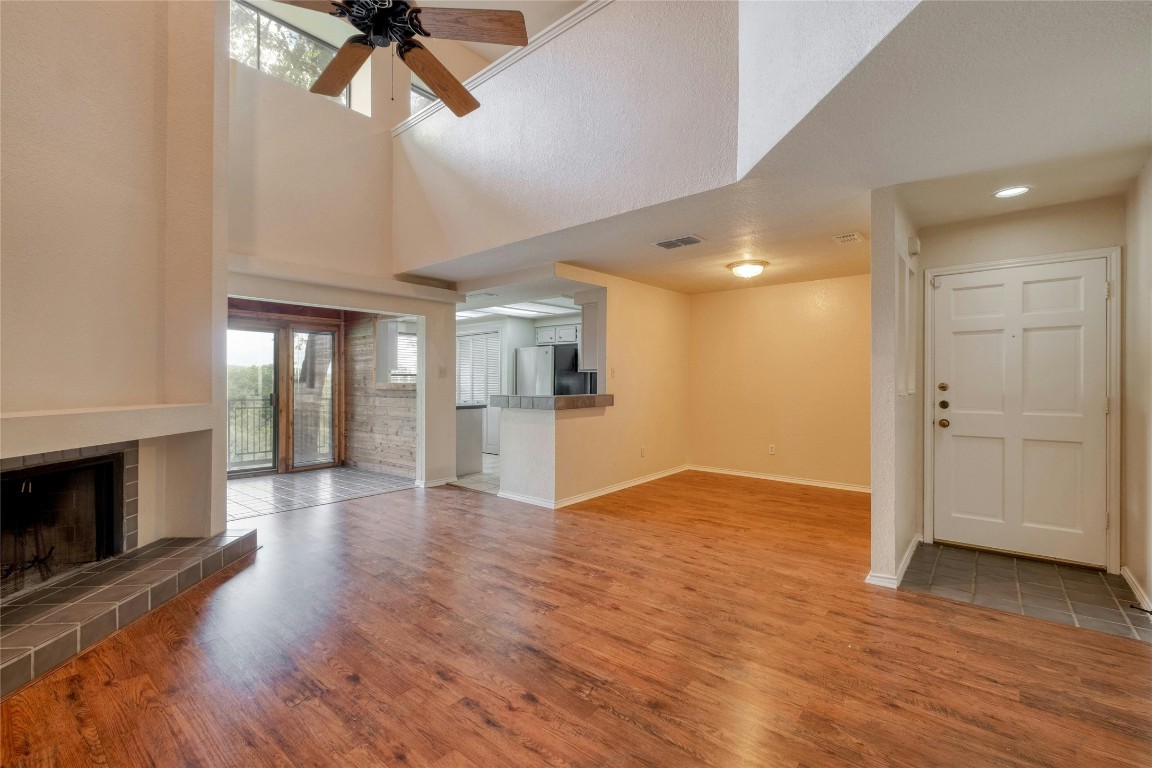 a view of empty room with wooden floor and fireplace