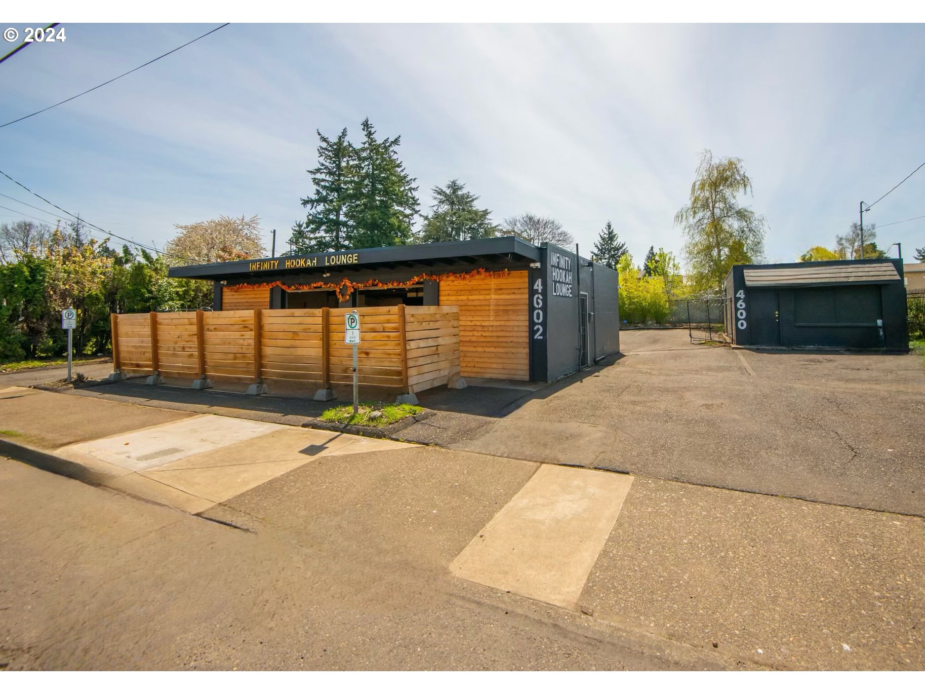 a backyard of a house with a basket ball court