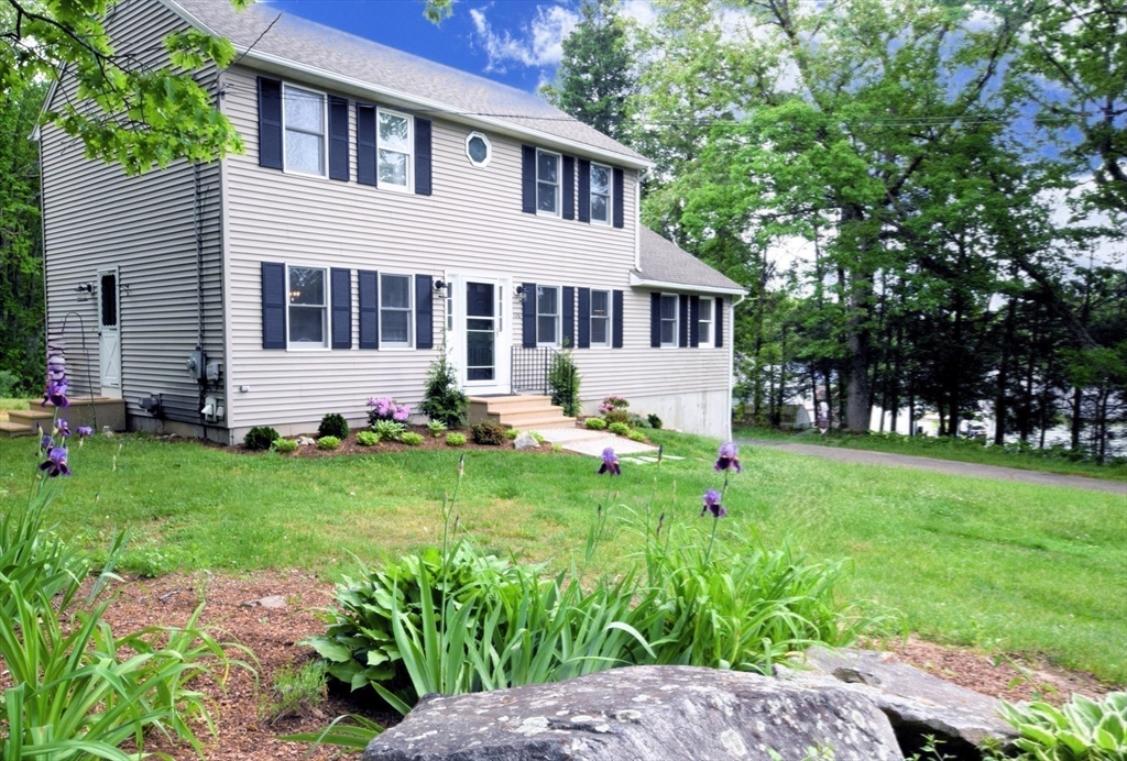 a front view of house with yard and green space