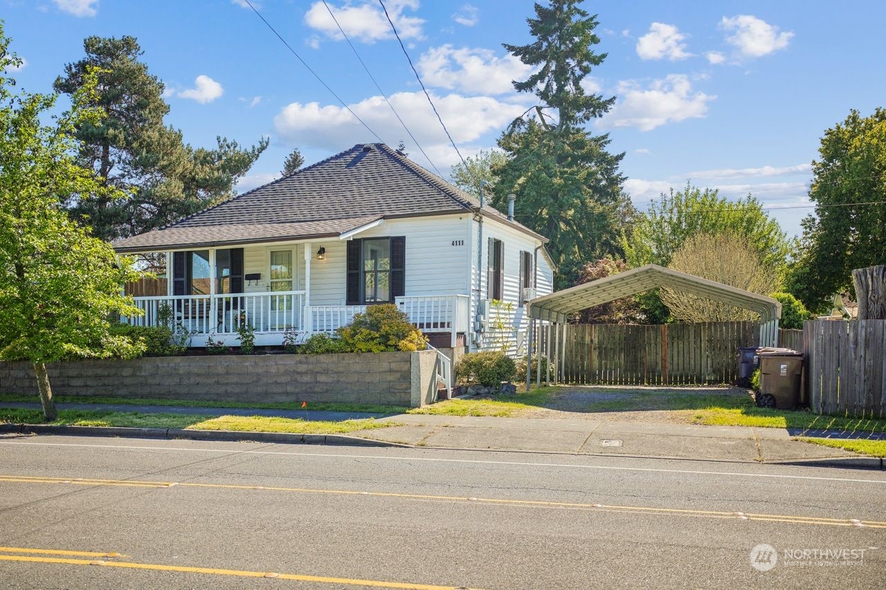 a front view of a house with a yard and potted plants