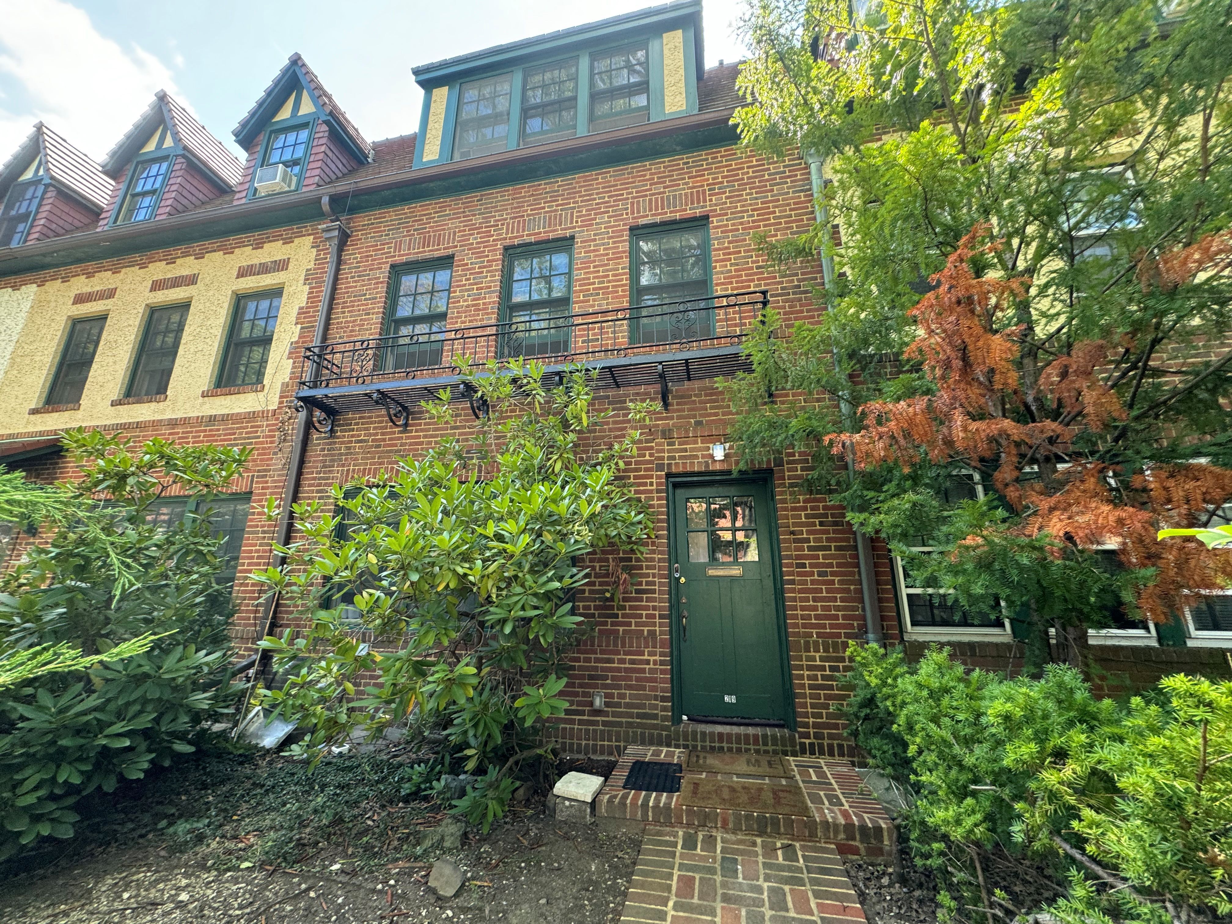 a front view of a house with plants